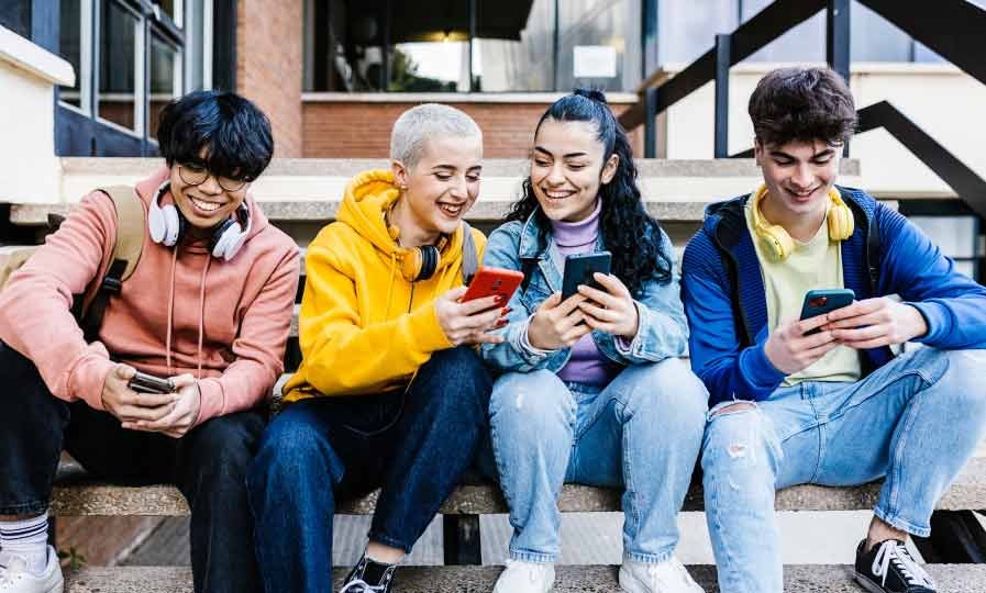A group of young students using mobile phones